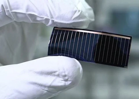 Flexible GaAs solar cell held in a curved configuration